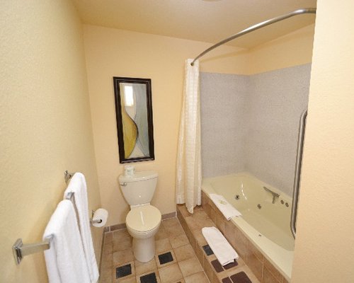 A bathroom with a toilet shower and bathtub.