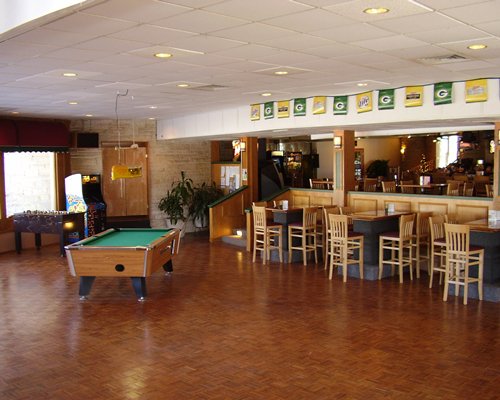 An indoor recreational room with pool table and arcade games.