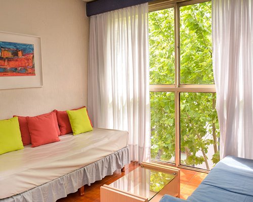 A well furnished bedroom with a dining table.