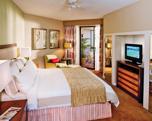 A well furnished bedroom with a television.