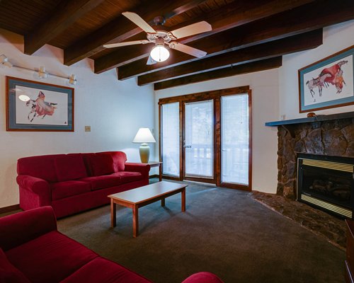 A well furnished living room with television and fireplace.
