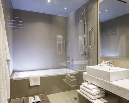 A bathroom with a shower bathtub and a sink vanity.