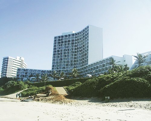 A beach view of multi story resort units.