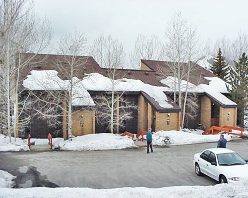 A street view of multiple resort condos covered by snow.