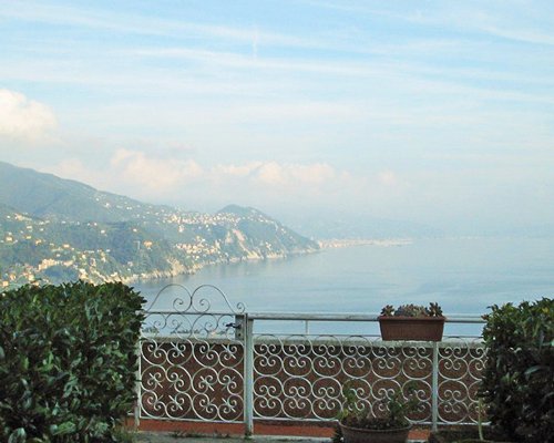 Scenic balcony with the view of ocean alongside mountains.