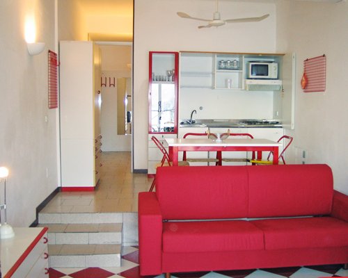 A well furnished living room with open plan kitchen and dining area.