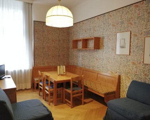 A well furnished living room with a television dining area and outdoor view.