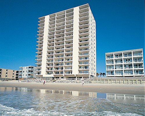 Exterior view of Atalaya Towers alongside the beach.