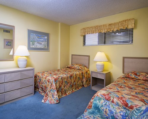 A well furnished bedroom with multiple twin beds.
