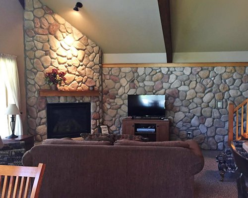 A well furnished living area with a television and fireplace.