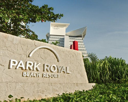Entrance of Royal Holiday Park Royal Cancun with parking lot.