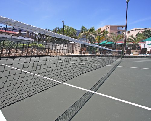 Outdoor recreation area with tennis court.