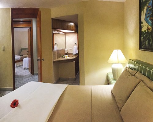 A well furnished bedroom alongside bathroom.