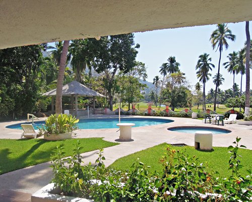 Scenic pathway leading to the outdoor swimming pool with hot tub.