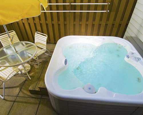 An indoor hot tub with patio furniture.