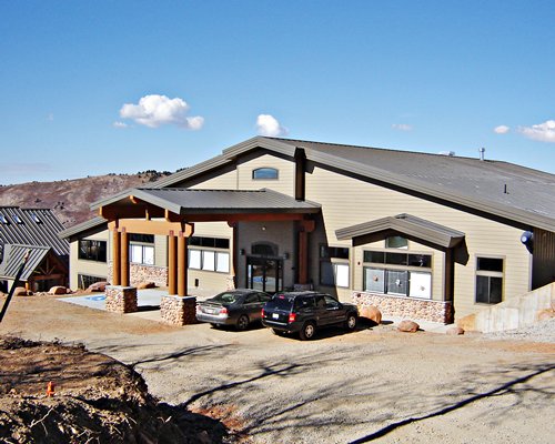 An exterior view of Powder Ridge Village with car parking area.