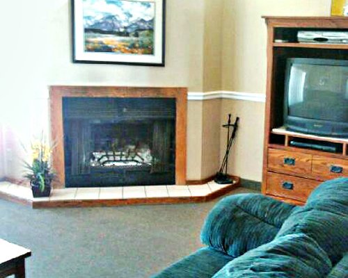 Living room with a television and fireplace.