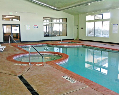 An indoor swimming pool with hot tub.