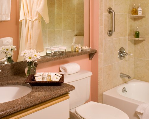 A bathroom with bathtub shower and sink.