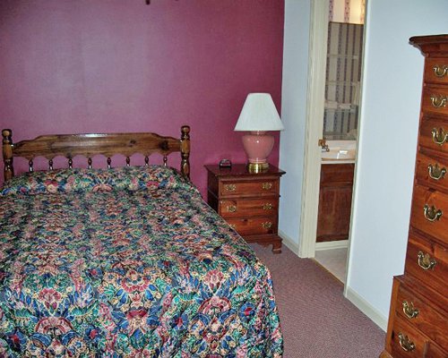 A well furnished bedroom with cupboard.