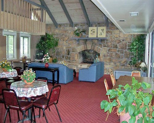 An open plan living dining area with a television and fireplace.