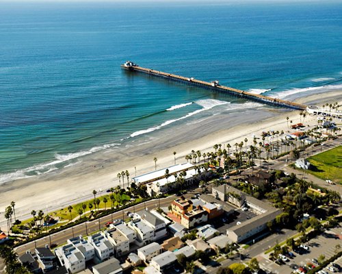 An aerial view of the resort property and pier leading to the ocean.