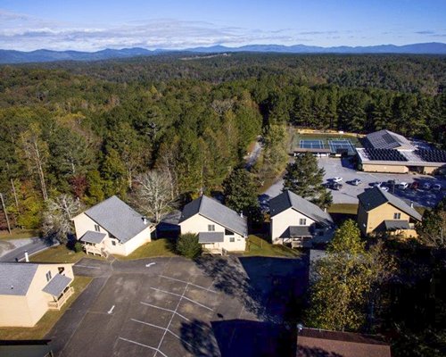 An aerial view of the resort proper surrounded by a wooded area.