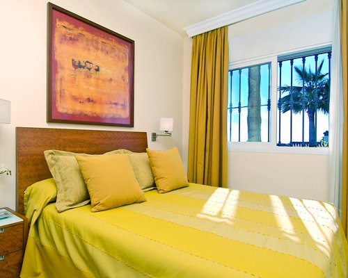 A well furnished bedroom with an outside view.