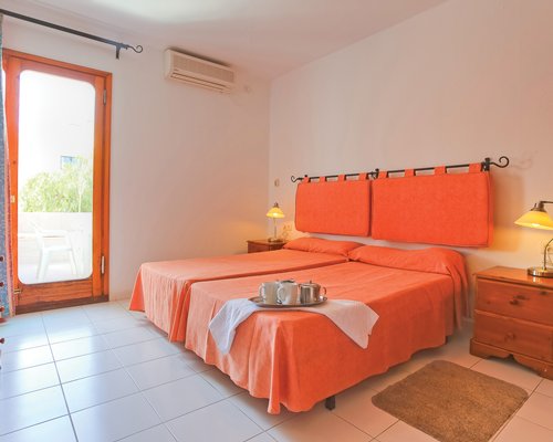 A well furnished bedroom with double bed and balcony.