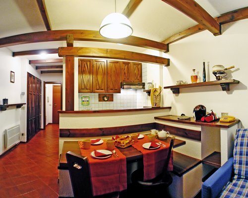A well furnished dining room alongside a kitchen.