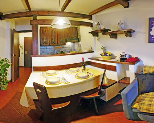 A well furnished dining area alongside kitchen.