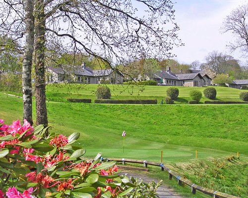 A golf course putting green alongside multiple resort units.