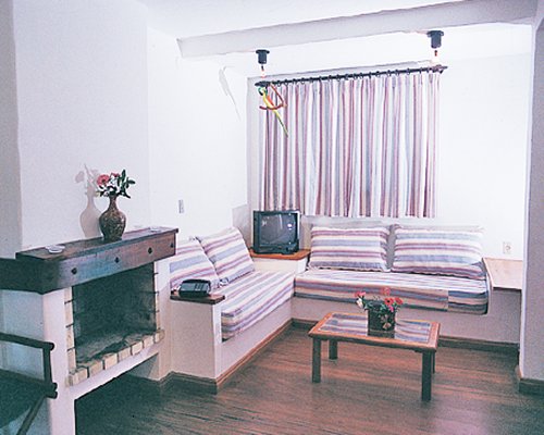 A well furnished living room with a television and fireplace.