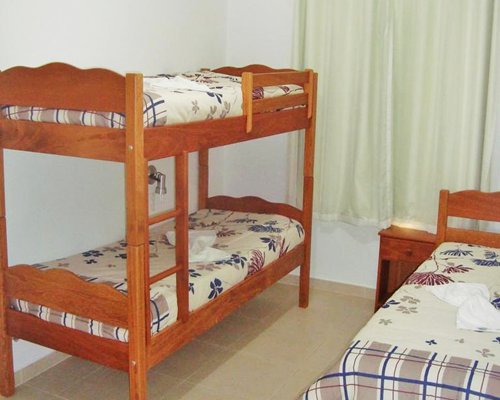 A well furnished bedroom with bunk beds.