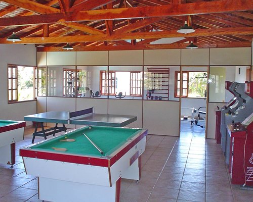 Indoor recreation area with pool table ping pong and arcade games.
