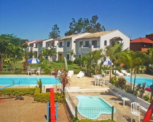 Outdoor swimming pool and hot tub with sunshades.