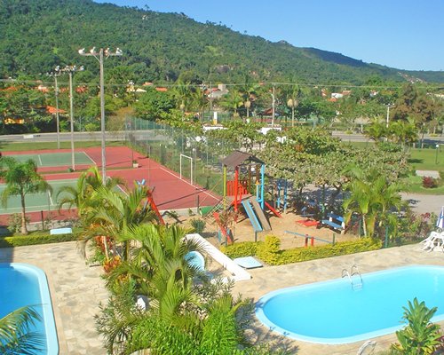 Outdoor recreation area alongside kids playscape and outdoor swimming pool.