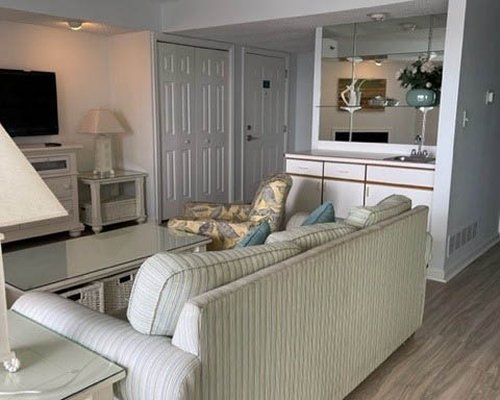 A well furnished bedroom with a television and an outside view.