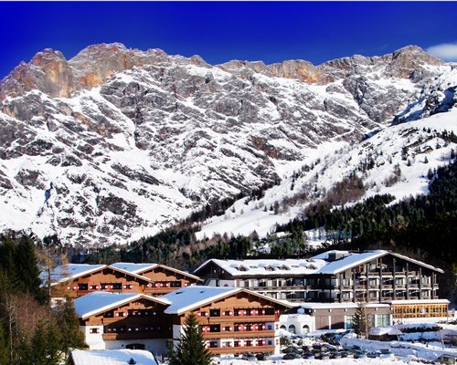 An aerial view of the Marco Polo Club Alpina resort covered in snow.