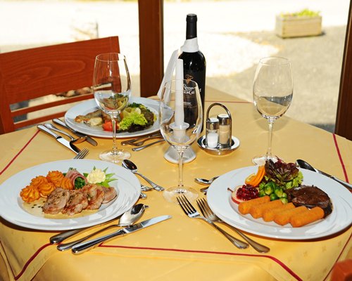 Indoor dining with food and beverages on the table.
