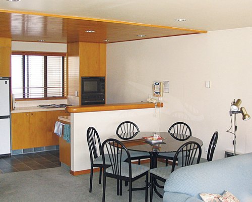 An open plan dining and kitchen area with breakfast bar.