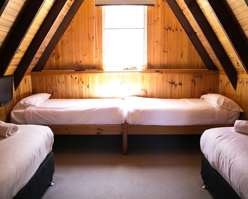 Furnished bedroom with multiple beds.