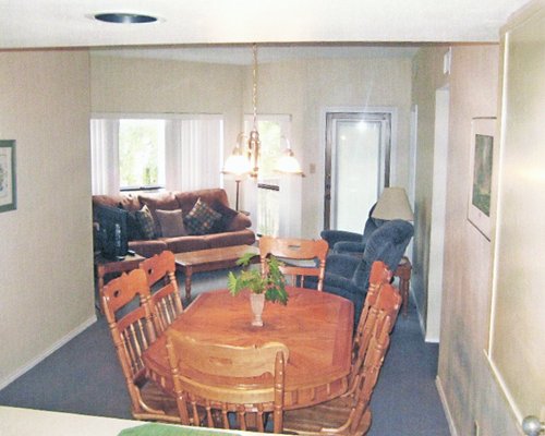 An open plan living room with a wooden dining table.
