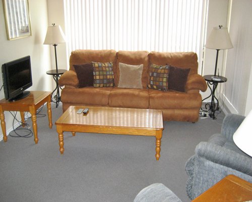 A well furnished living room with a television and outside view.