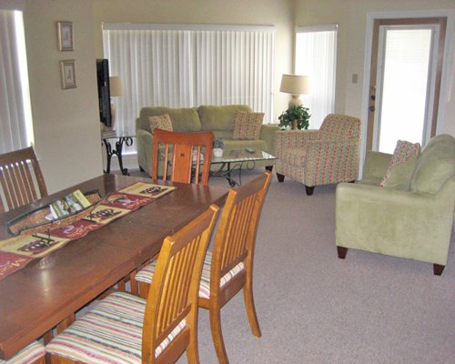 An open plan living room and wooden dining table.