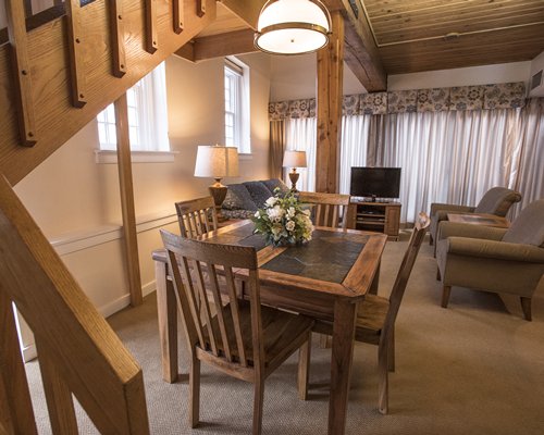 An open plan living room and dining area with a television.