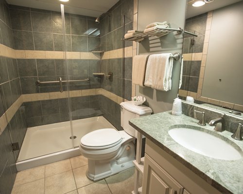 A bathroom with shower stall and closed sink vanity.
