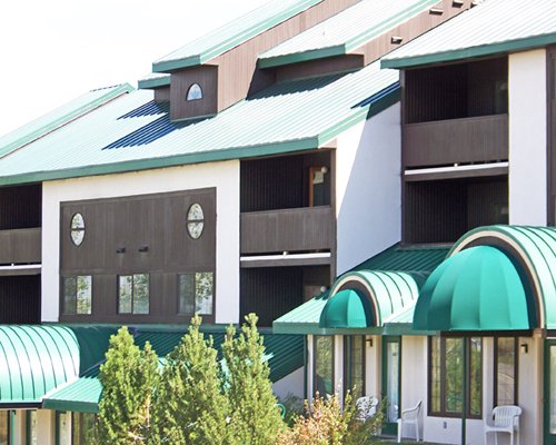 Exterior view of Goldenwoods Condominiums with multiple balconies and landscaping.