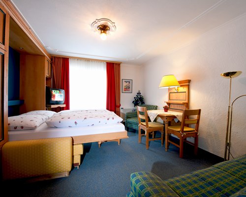 A well furnished bedroom with a television.