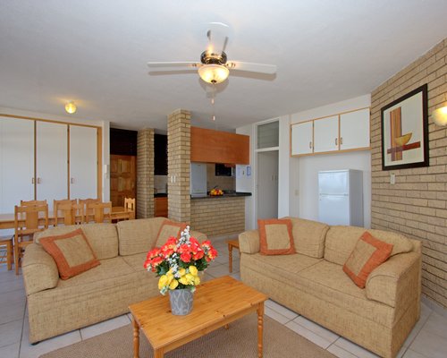 An open plan living and dining area alongside kitchen.